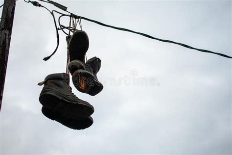 boots hanging on wire.